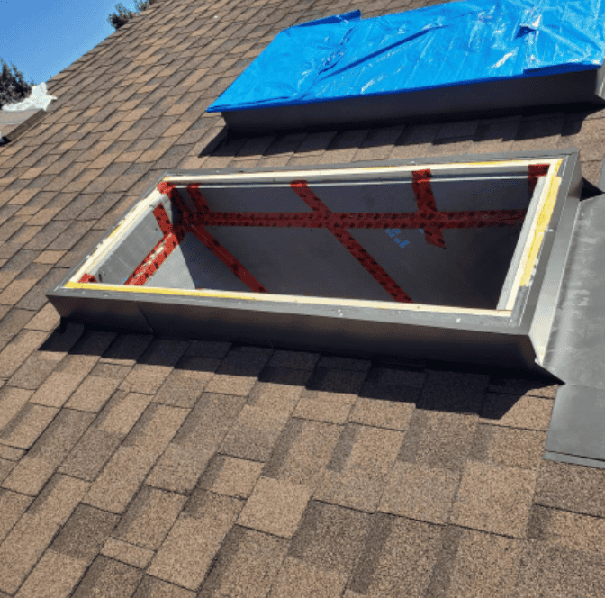 Skylight being repaired on the roof of a house