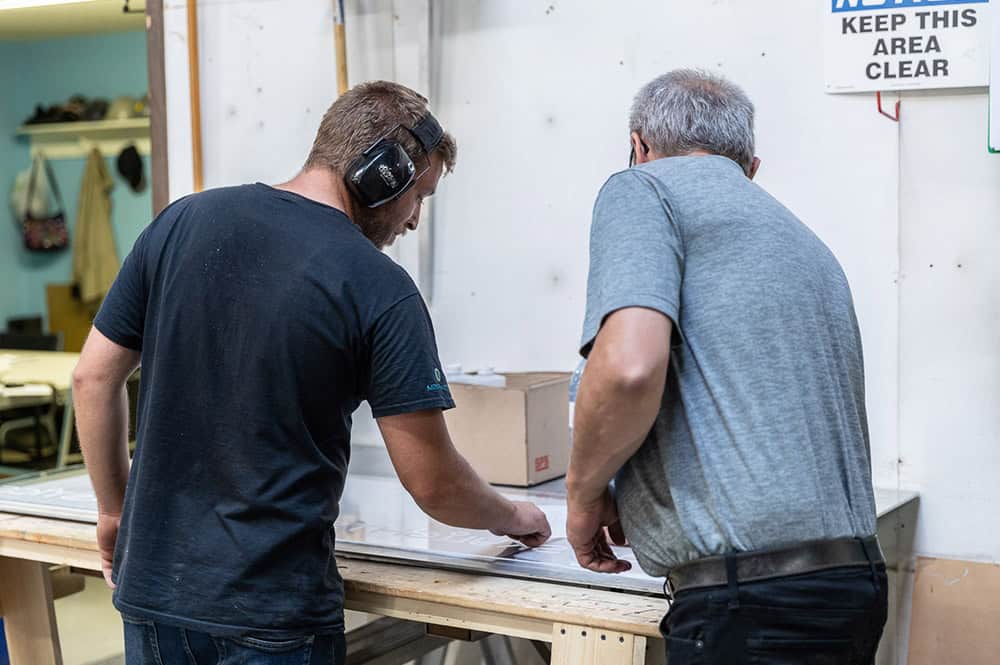 Mac Plastics & Skylights Employees inspecting a design